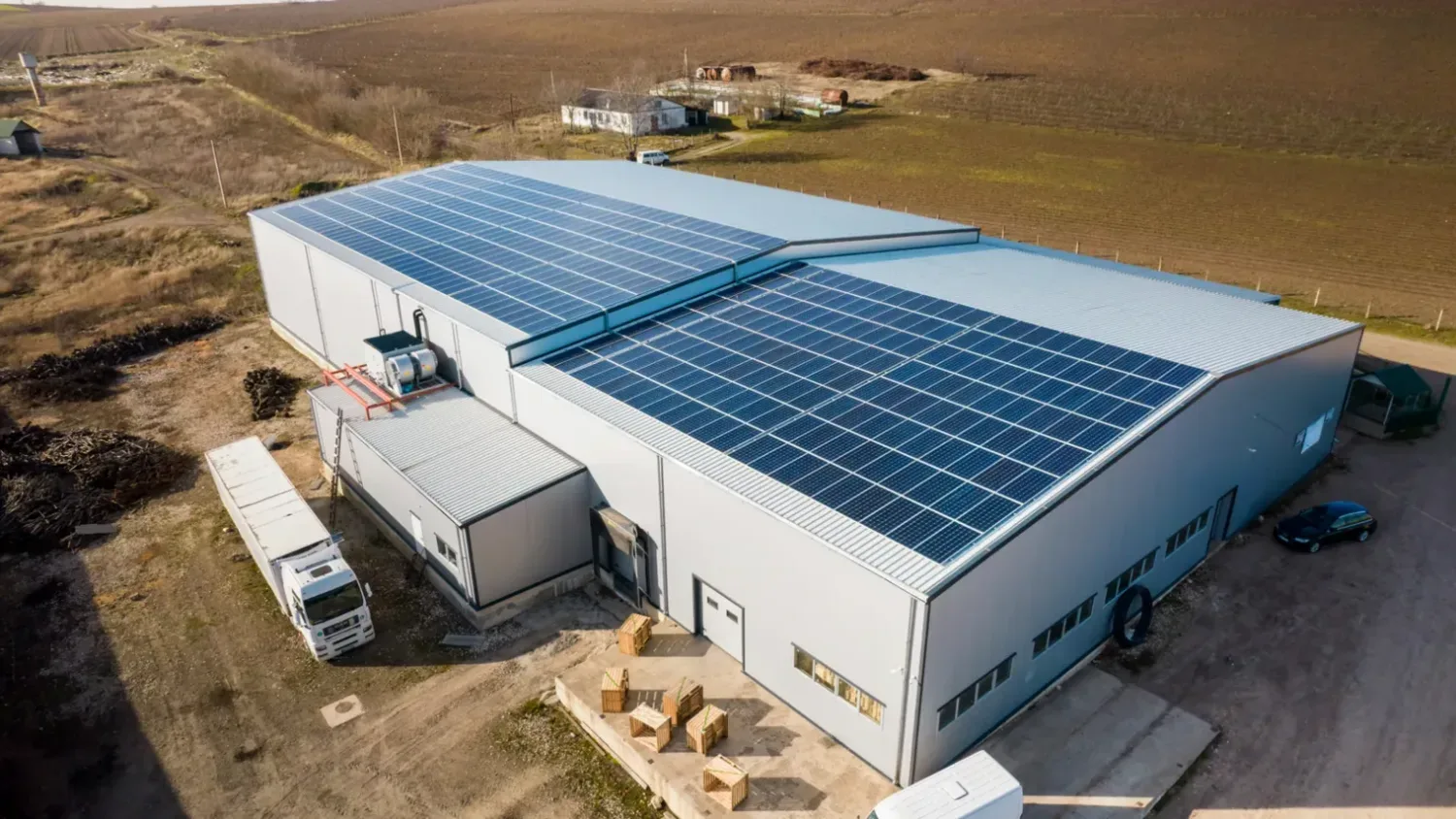 Aerial view of a commercial warehouse rooftop solar array