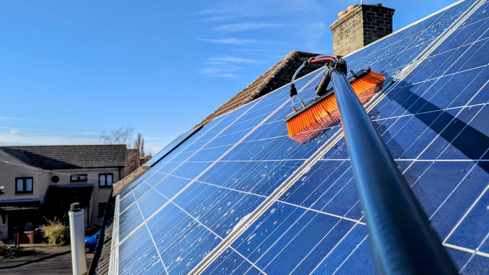 Soft-brush cleaning of a rooftop solar array in Queensland